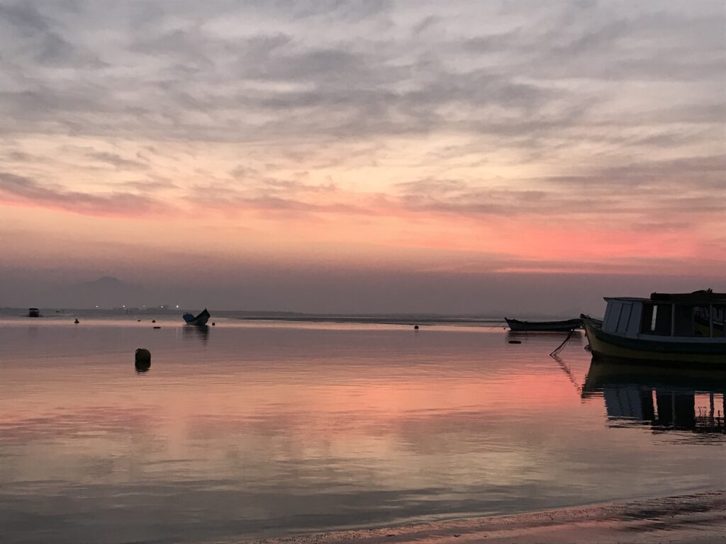 Boats anchored in the bay at dawn on Ilha do Mel